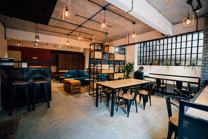 Green double couch with wooden legs