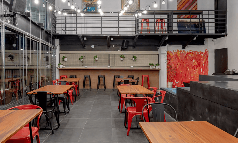 Green double couch with wooden legs